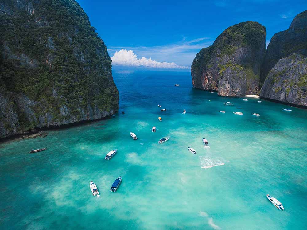 Phuket’s Vibrant Tourist Boats and Idyllic White Sandy Beaches: A Tropical Paradise Explored